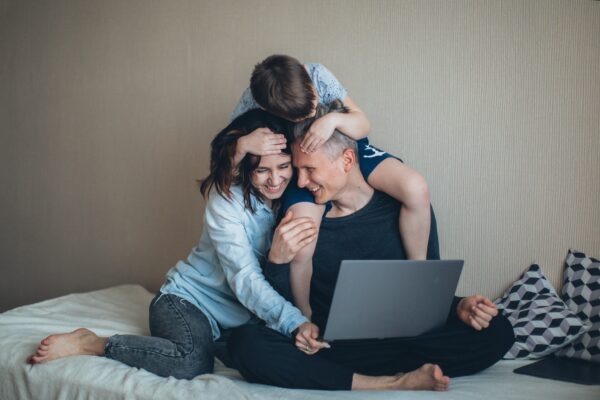 Happy family with laptop and mortgage protection