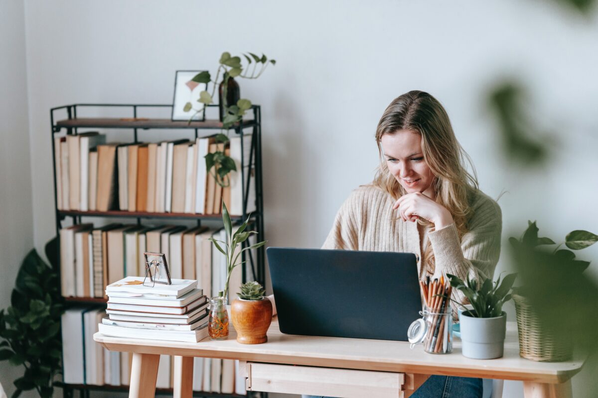 Self-employed person working at a desk with a laptop trying to get a mortgage