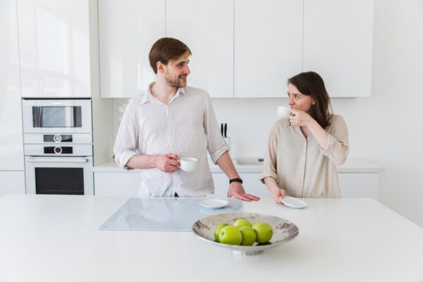 Couple in the kitchen with mugs