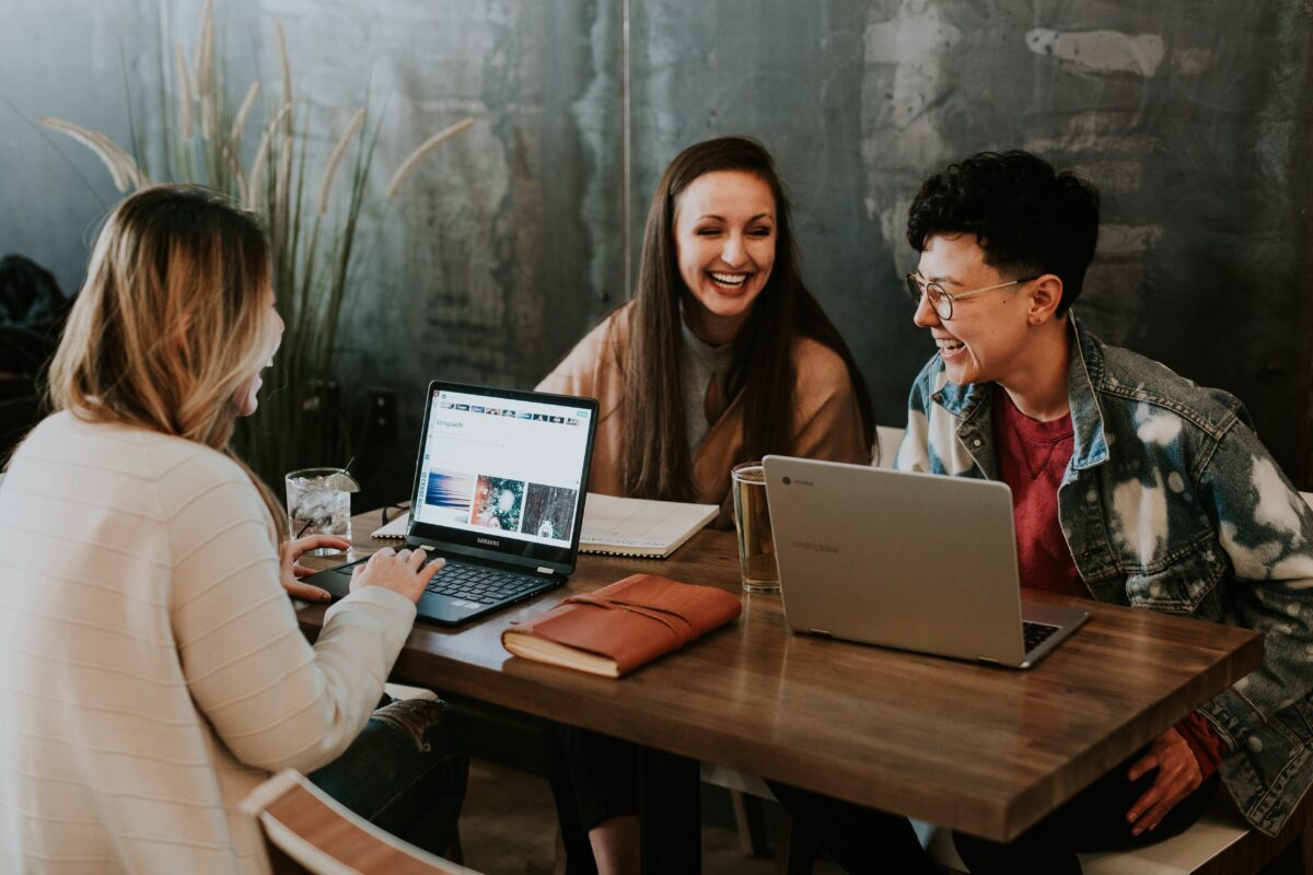 young couple talking over a desk to a mortgage advisor