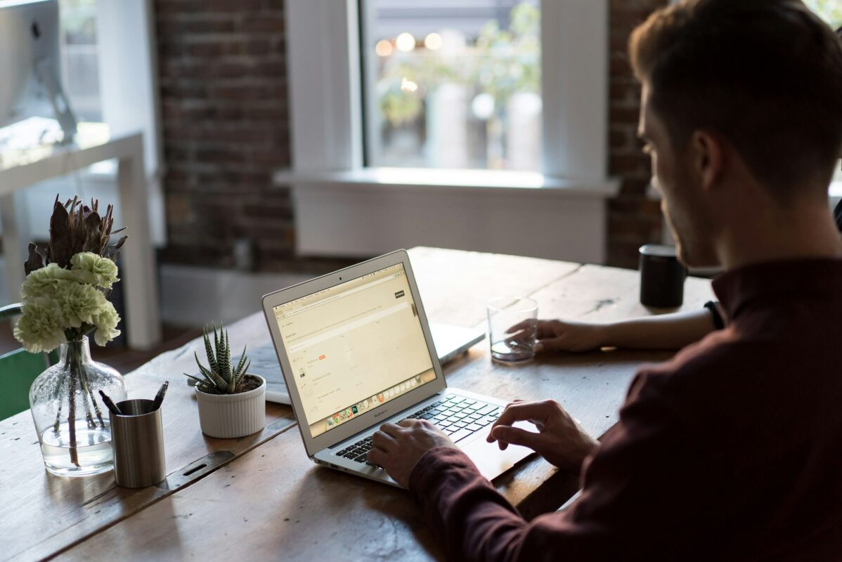 man at laptop on desk new job looking for a mortgage