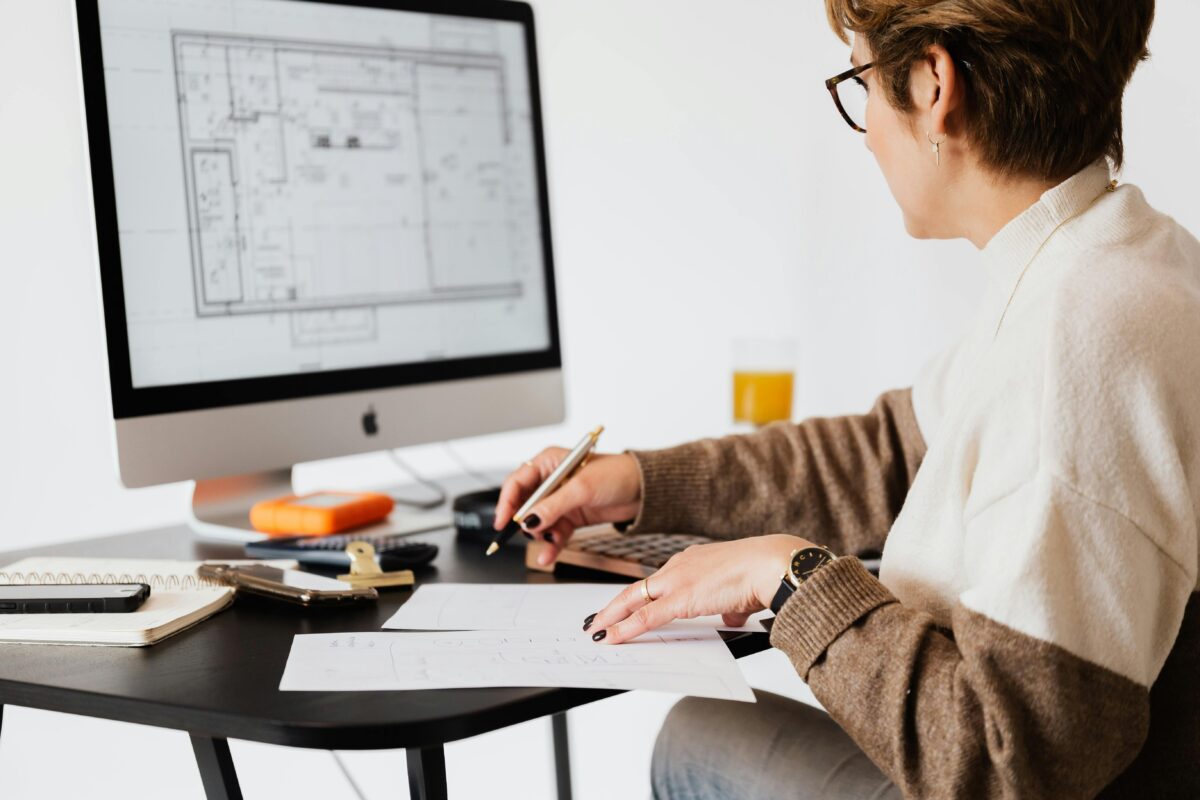 woman looking at architect plans for home improvement and extension funding with remortgage