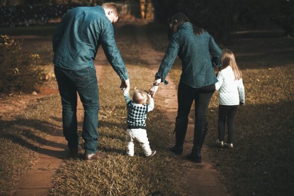 happy family out walking able to pay mortgage on sick leave