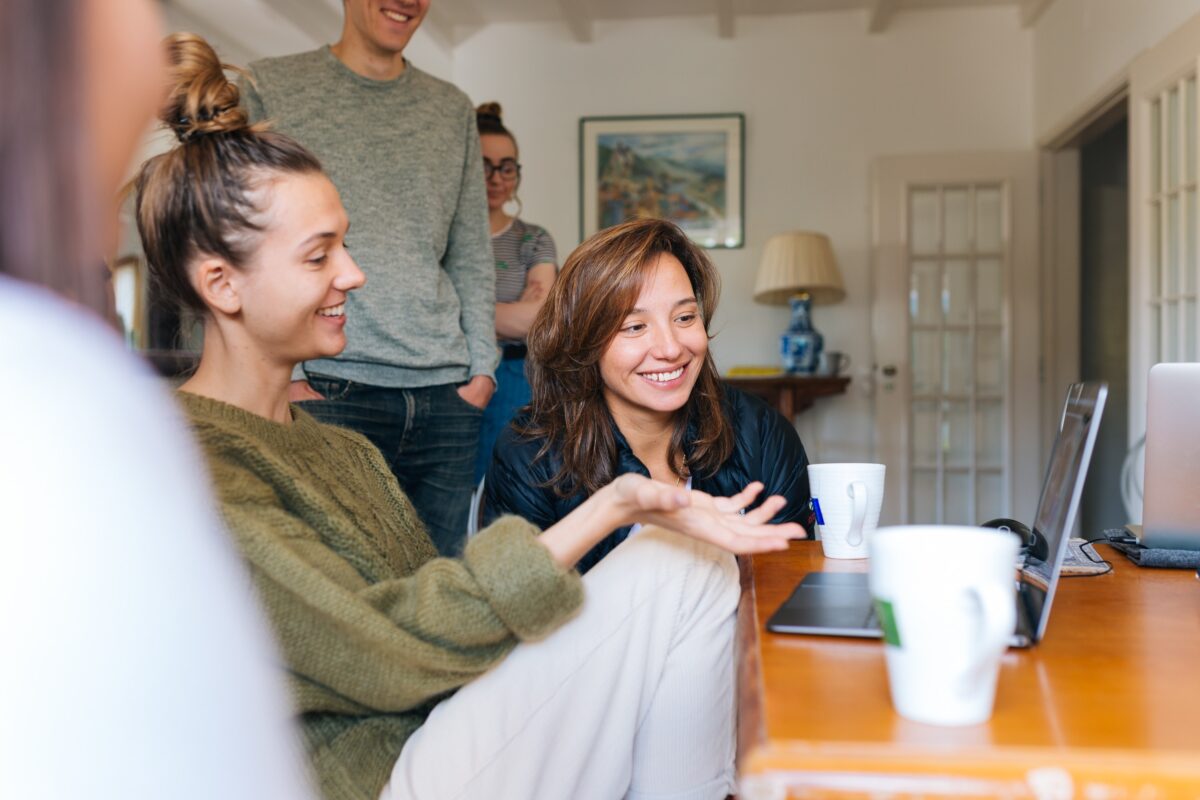 Young adult first-time buyer at laptop with parent getting mortgage