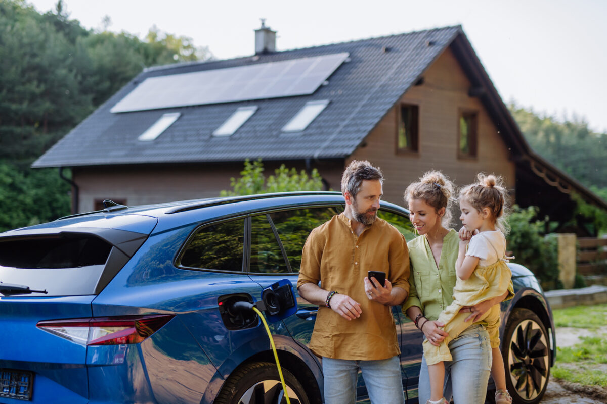 Eco friendly house with family outside and electric car want a green mortgage